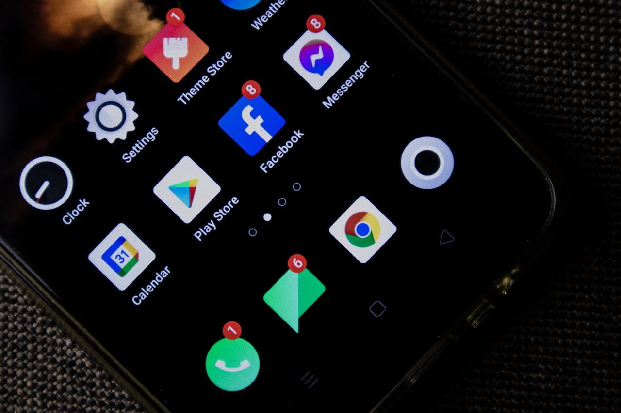 Close-up of a smartphone screen displaying various social media and app icons.